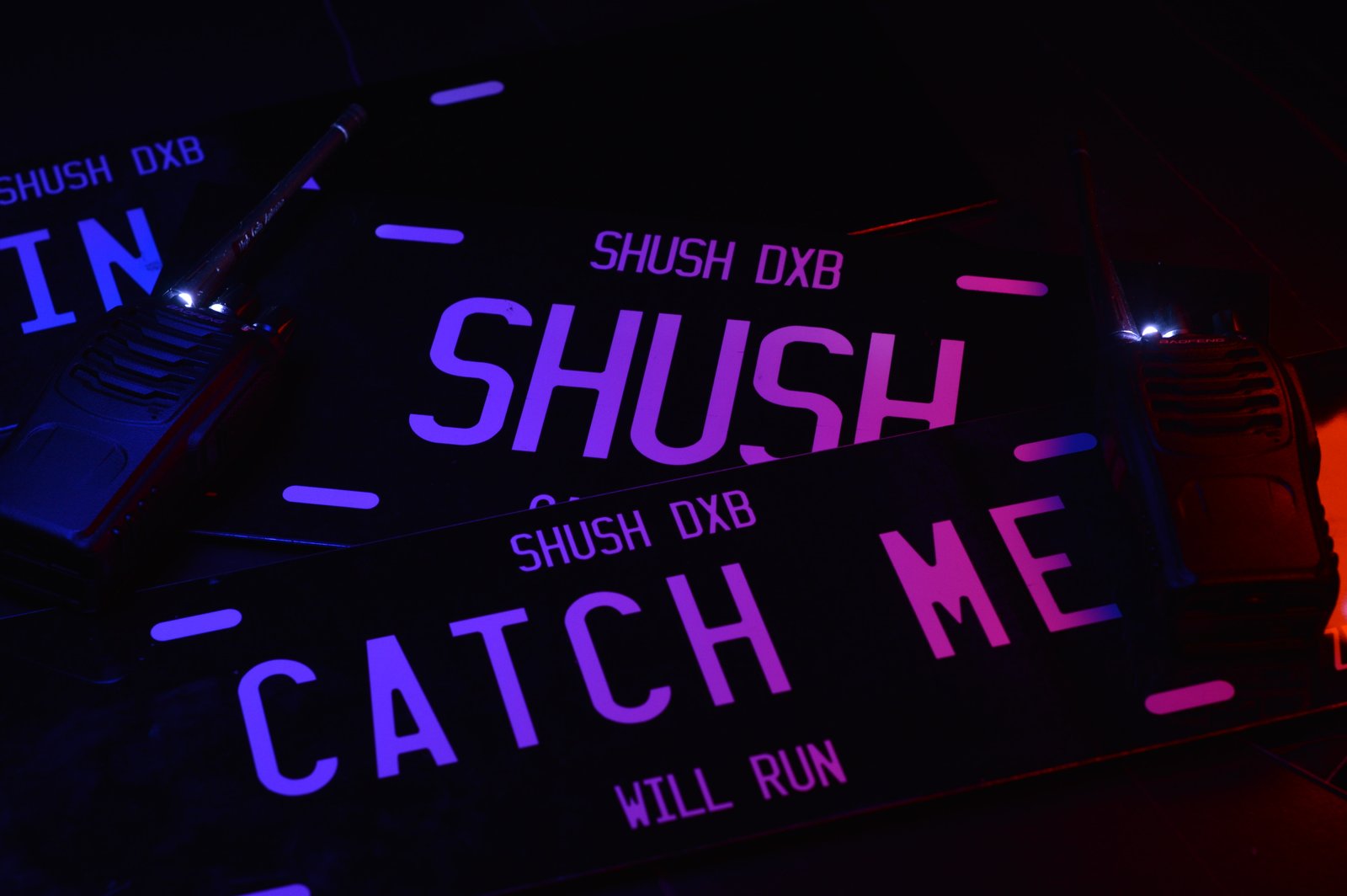SHUSH plates with purple neon